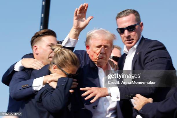 Republican presidential candidate former President Donald Trump is rushed offstage during a rally on July 13, 2024 in Butler, Pennsylvania. Butler...