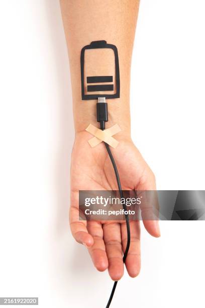 the usb charging cable plugged into the hand - battery life stock pictures, royalty-free photos & images
