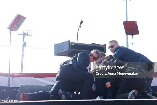 Republican presidential candidate former President Donald Trump is rushed offstage during a rally on July 13, 2024 in Butler, Pennsylvania. Butler...