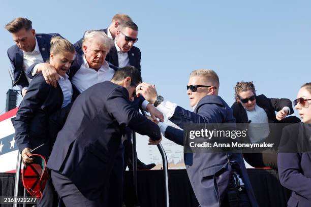 Republican presidential candidate former President Donald Trump is rushed offstage during a rally on July 13, 2024 in Butler, Pennsylvania. Butler...
