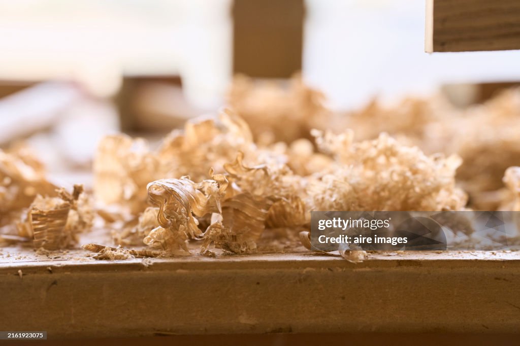 Close-up of a pile of sawdust on a workbench in a carpentry workshop without people, side view.