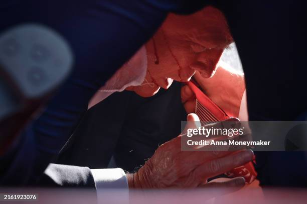 Republican presidential candidate former President Donald Trump is shown covered by U.S. Secret Service agents after an incident during a rally on...