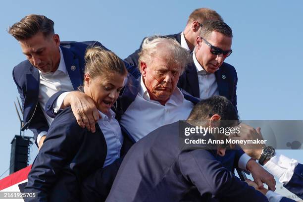 Republican presidential candidate former President Donald Trump is rushed offstage by U.S. Secret Service agents after being grazed by a bullet...