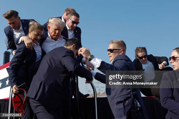 Republican presidential candidate former President Donald Trump is rushed offstage by U.S. Secret Service agents after being grazed by a bullet...