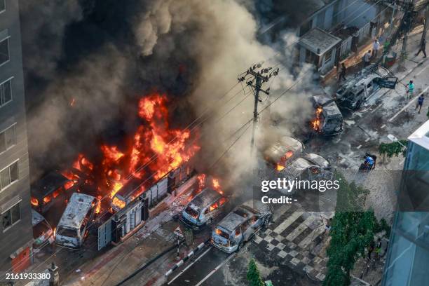 Smoke rises from the burning vehicles after protesters set them on fire near the Disaster Management Directorate office, during the ongoing...