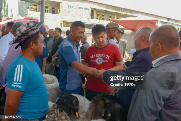 kashgar, china - june 1, 2024: local folks were making deal on sheep in the livestock market. - goat seller stock pictures, royalty-free photos & images