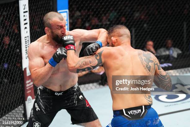 Muslim Salikhov of Russia elbows Santiago Ponzinibbio of Argentina in a welterweight fight during the UFC Fight Night event at Ball Arena on July 13,...