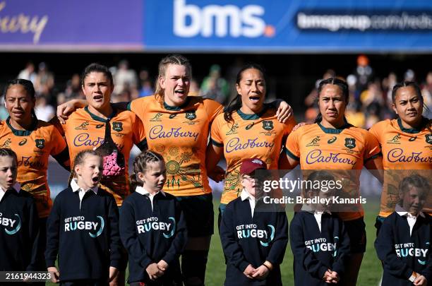 The Wallaroos embrace during the national anthem before the International Test Match between Australia Wallaroos and New Zealand Black Ferns at...