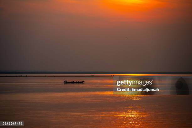fishermen at twilight on the padma river in rajshahi, bangladesh - padma river stock pictures, royalty-free photos & images