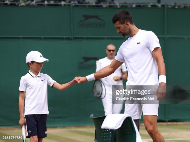 Novak Djokovic of Serbia interacts with his son, Stefan Djokovic as he practices ahead of the Gentlemen's Singles Final against Carlos Alcaraz of...