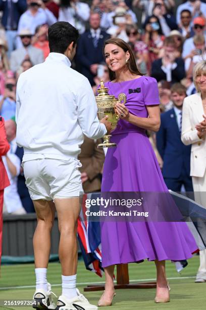 Catherine Princess of Wales presents the winner's trophy to Spain's Carlos Alcaraz after beating Serbia's Novak Djokovic during their men's singles...