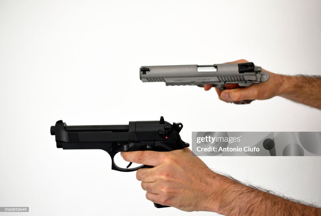 Close-up of a man in a shootout using two handguns