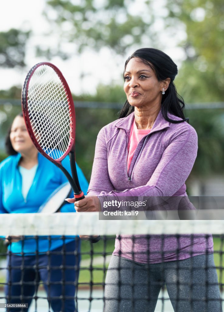 Senior African-American women playing tennis