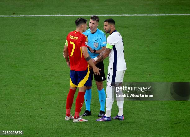 Kyle Walker of England interacts with Alvaro Morata of Spain and Referee Francois Letexier during the UEFA EURO 2024 final match between Spain and...