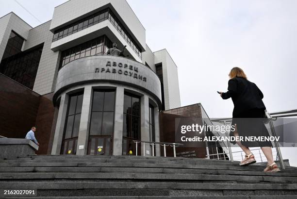 People walk to enter the Sverdlovsk Regional Court building prior to a hearing in the trial of US journalist Evan Gershkovich, accused of espionage,...