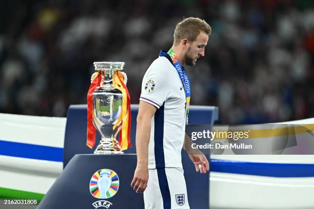 Harry Kane of England looks dejected as he walks past the UEFA Euro 2024 Henri Delaunay Trophy after the team's defeat in the UEFA EURO 2024 final...
