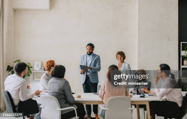 diverse business meeting in bright modern office - staff meeting stock pictures, royalty-free photos & images