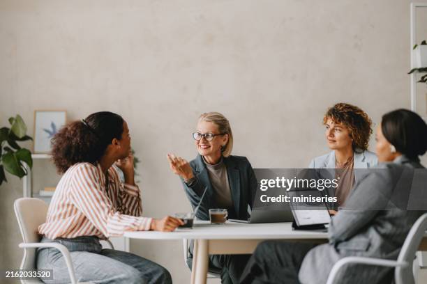 business team meeting in bright modern beige office - beige stock pictures, royalty-free photos & images