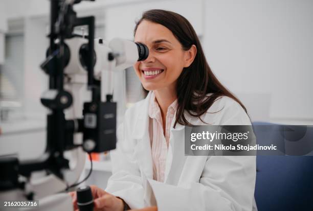 an eye exam - ophthalmologist stock pictures, royalty-free photos & images