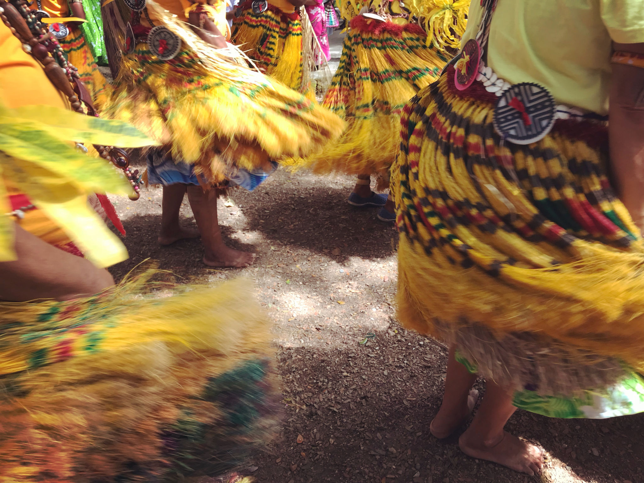 The swirling of yellow skirts during a traditional barefoot dance in Papua New Guinea The swirling of yellow skirts during a traditional barefoot dance in Papua New Guinea