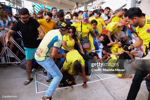Fans of Colombia and Argentina try to pass the gate amid disturbances the CONMEBOL Copa America 2024 Final match between Argentina and Colombia at...