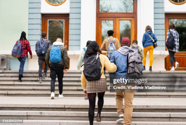 pupils climbing the steps towards the building - voortgezet onderwijs gebouw stockfoto's en -beelden