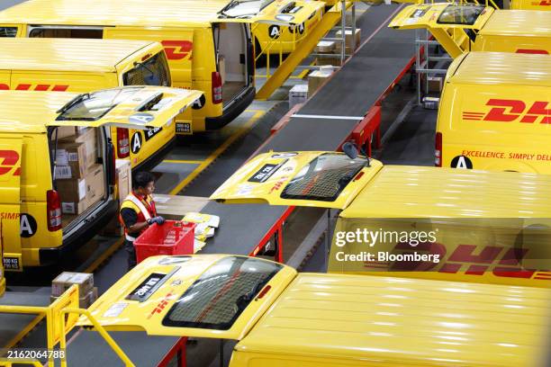 An employee handles packages inside the DHL Express Service Center facility in Shah Alam, Selangor, Malaysia, on Wednesday, July 17, 2024. Malaysia's...
