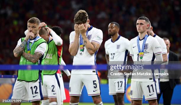 Kieran Trippier of England John Stones of England Phil Foden of England look dejected following defeat in the the UEFA EURO 2024 final match between...