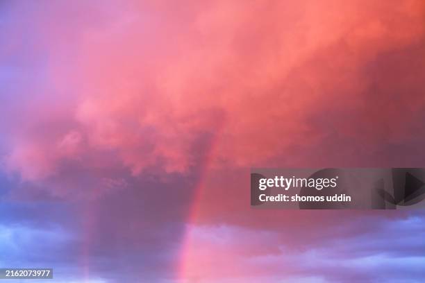 dramatic sky with rainbow at sunset - rainbow stock pictures, royalty-free photos & images
