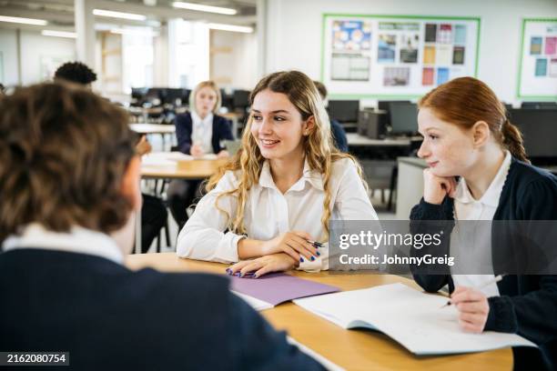 teenage schoolgirls sitting at round table with classmates - female high school student stock pictures, royalty-free photos & images