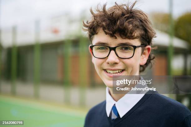 outdoor headshot of cheerful british schoolboy - boys stock pictures, royalty-free photos & images