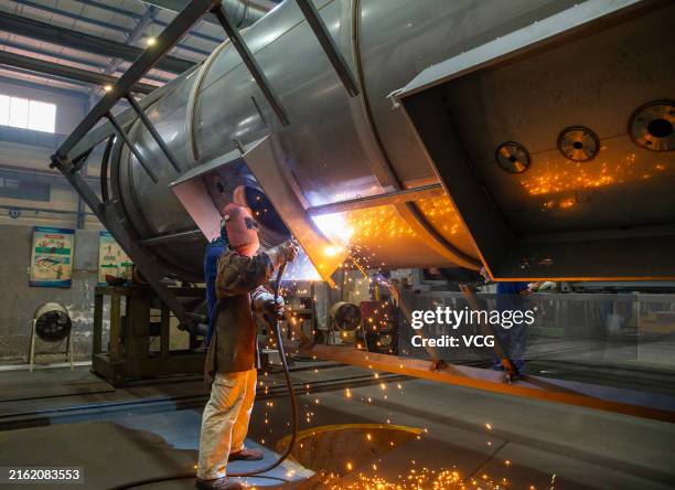 Worker produces specialized tank containers for export at Square Technology Group Co., Ltd. On July 15, 2024 in Nantong, Jiangsu Province of China.