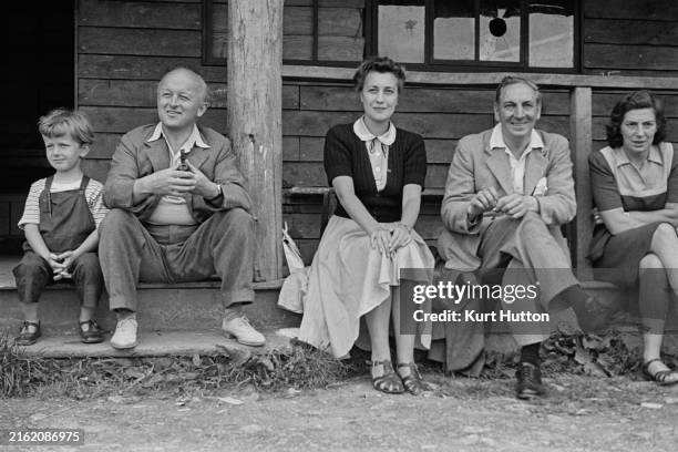 Headmaster of Dartington School William Burnlee Curry , Margaret Room and MP for Llanelli Jim Griffiths , watch a game of cricket during a Fabian...