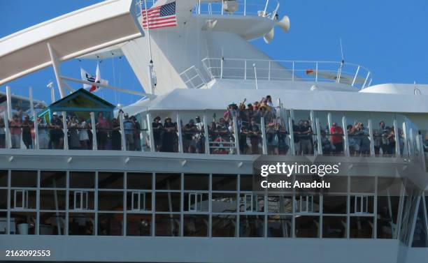 Passengers wave as Royal Caribbean's newest cruise ship, Utopia of the Seas, sails from Port Canaveral on its inaugural cruise with paying customers...