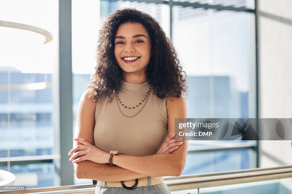 Woman, portrait and happy in office with arms crossed, fashion mogul and pride with entrepreneur. Clothing design, company and confident for career in bright workplace, smile and female boss