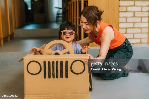 asian little girl playing in diy cardboard car with her family - cardboard car stock pictures, royalty-free photos & images