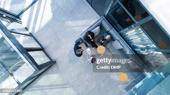 Business people, top view and meeting in building with collaboration, financial pitch with document for strategy. Above, tax accountant and table teamwork with budget paper for economy in office Business people, top view and meeting in building with collaboration, financial pitch with document for strategy. Above, tax accountant and table teamwork with budget paper for economy in office