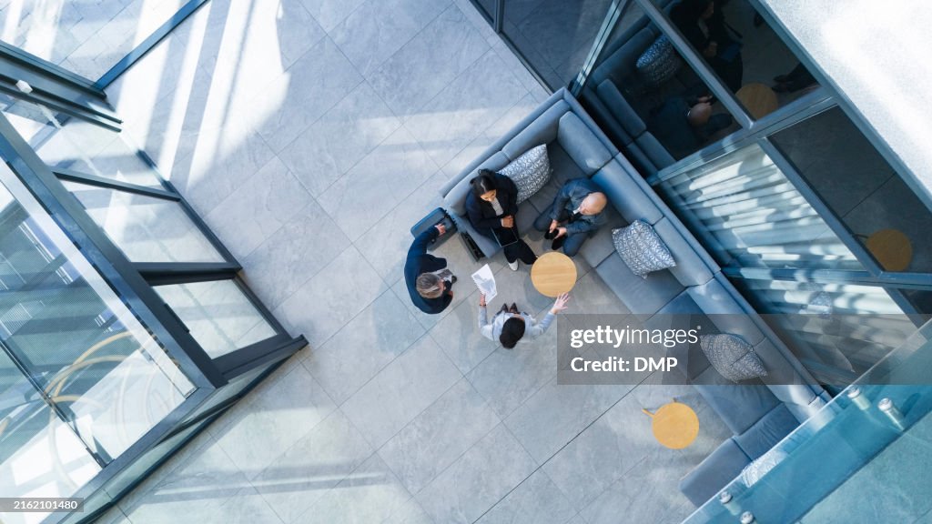 Business people, top view and meeting in building with collaboration, financial pitch with document for strategy. Above, tax accountant and table teamwork with budget paper for economy in office