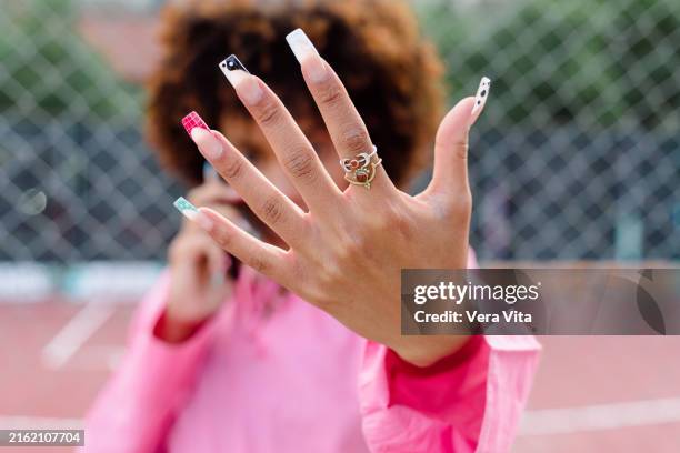 unrecognizable african woman hand with manicure in a basketball court - manicure stock pictures, royalty-free photos & images