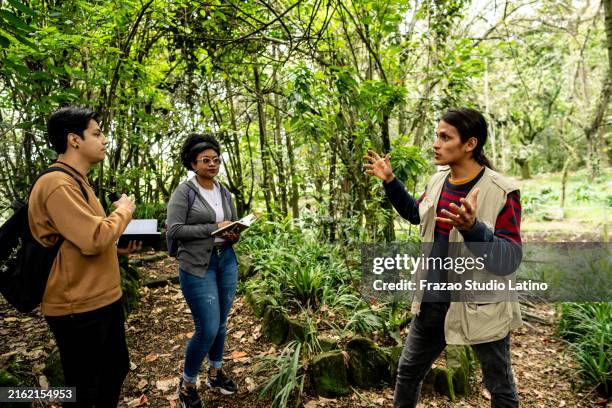 students friends on a botanical expedition - botanist stock pictures, royalty-free photos & images