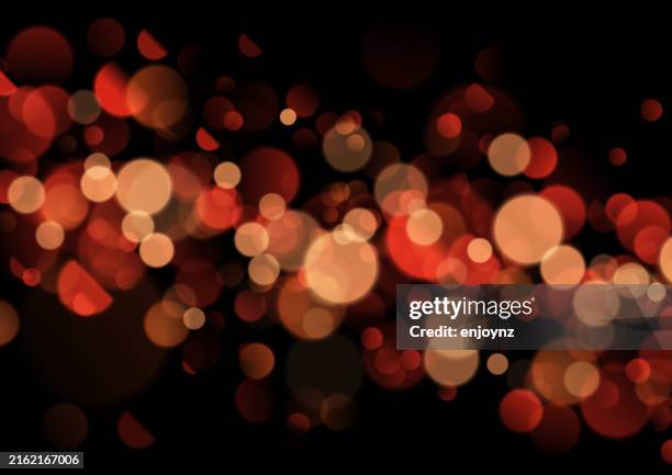 red sparkling out of focus glittering bokeh lights - lens flare black background stock illustrations