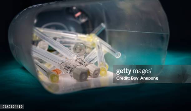 used medical needles inside infectious substances. infectious substances are substances which are known to contain, or are reasonably expected to contain, pathogens. - sewing needle stock pictures, royalty-free photos & images