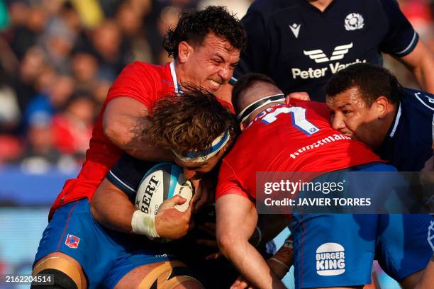 Scotland's hooker Jaime Ritchie struggles with Chile's number eight Raimundo Martinez during the Rugby Union test match between Chile and Scotland at...