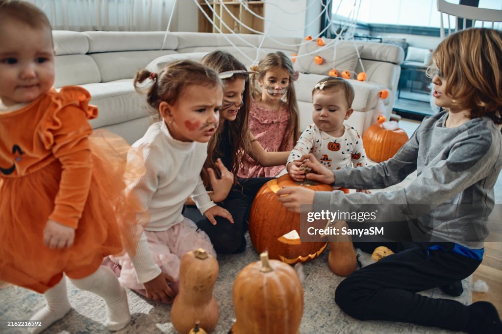 A group of children playing hocus pocus on a Halloween day