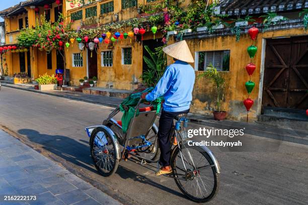 vietnamese cycle rickshaw in old town in hoi an city, vietnam - hoi an stock pictures, royalty-free photos & images