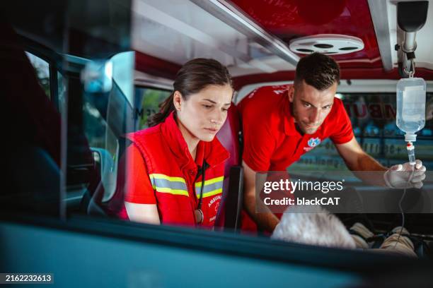 paramedics providing critical emergency care to a patient in ambulance - emergency rescue stock pictures, royalty-free photos & images
