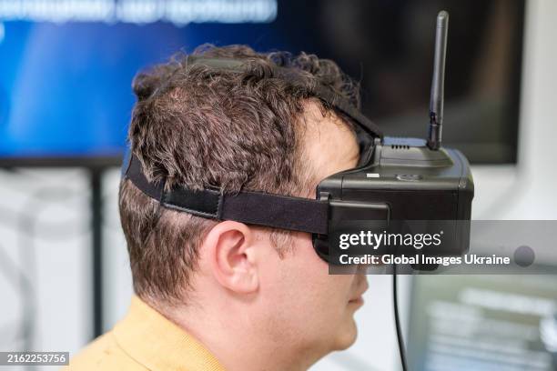 Operator candidate tries on goggles while working with UAV simulator at the recruiting centre of Ukrainian Army on July 16, 2024 in Lviv, Ukraine....
