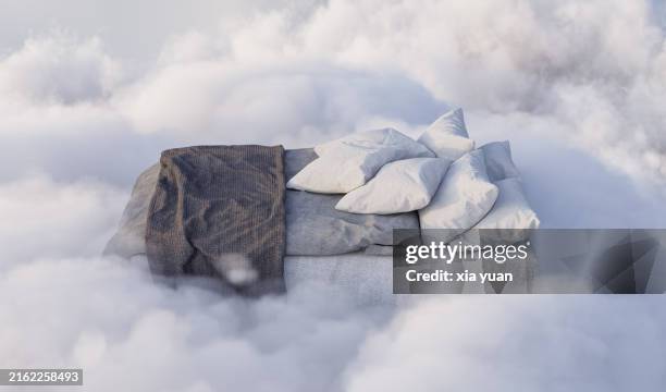 bed flying in the clouds - dekbed stockfoto's en -beelden