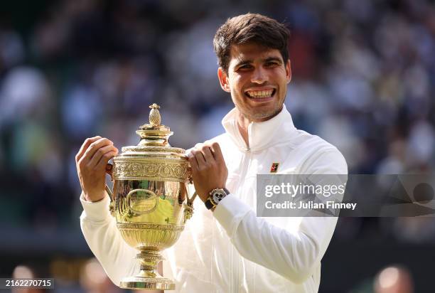 Carlos Alcaraz of Spain celebrates with the trophy after defeating Novak Djokovic of Serbia in the Gentlemen's Singles Final during day fourteen of...