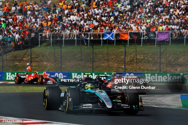 Sir Lewis Hamilton, Mercedes F1 W15, leads Charles Leclerc, Ferrari SF-24 during the F1 Grand Prix of Hungary at Hungaroring on July 21, 2024 in...